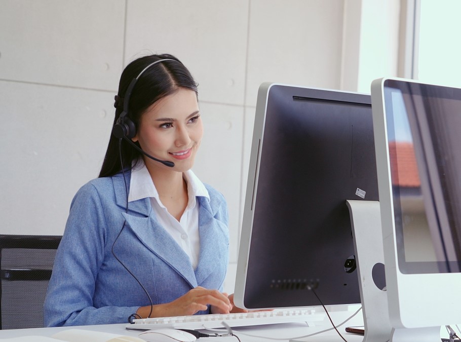 A man making a call while smiling & a blue gradient background.