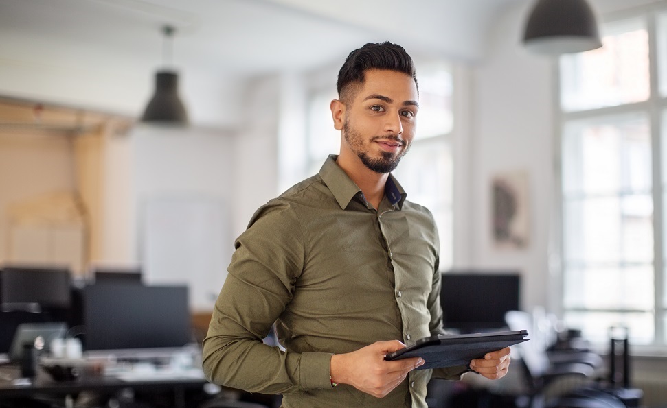 A man holding a tablet | emerging tech roles