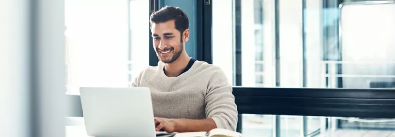 Guy sitting in front of laptop