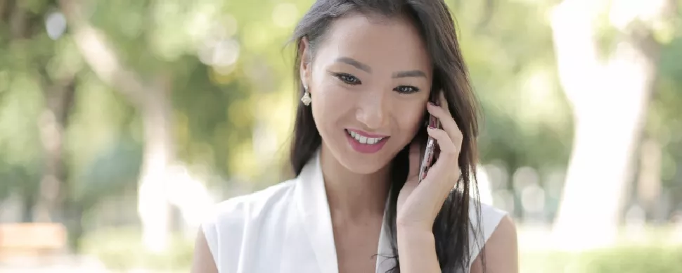 female Asian professional in her 30s on the phone