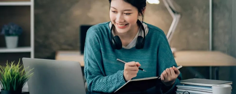 Woman-Smiling-While-Using-a-Laptop