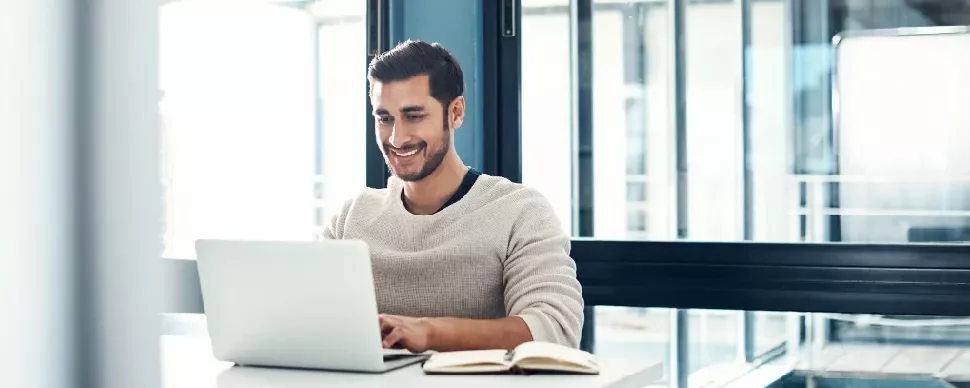 Guy sitting in front of laptop